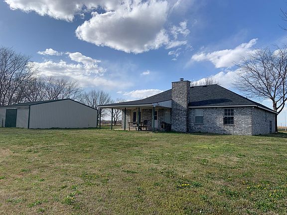 Back of house and shed. Back patio with doors to both living room and master.