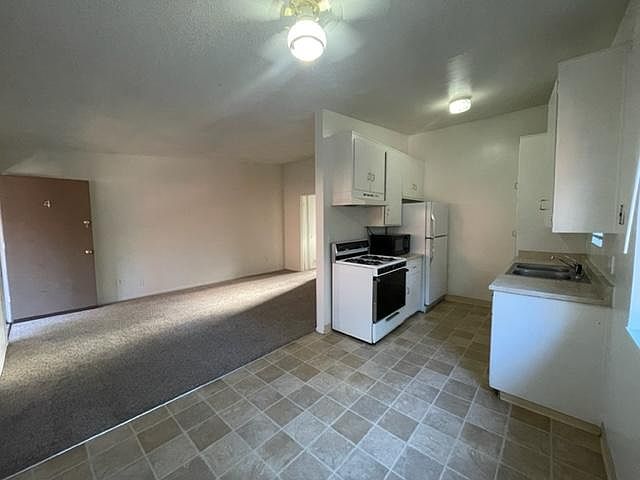 Kitchen and living area view from corner of dining area
