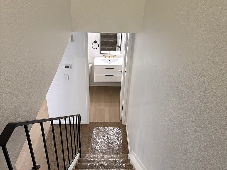 Stairs down, brand new carpet