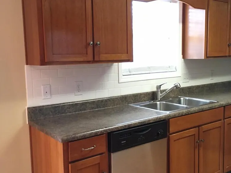 Cherry cabinets. Dishwasher and garbage disposal
