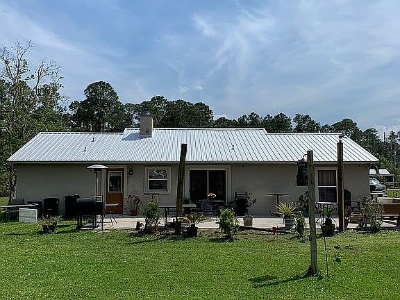 Back of home w/ patio