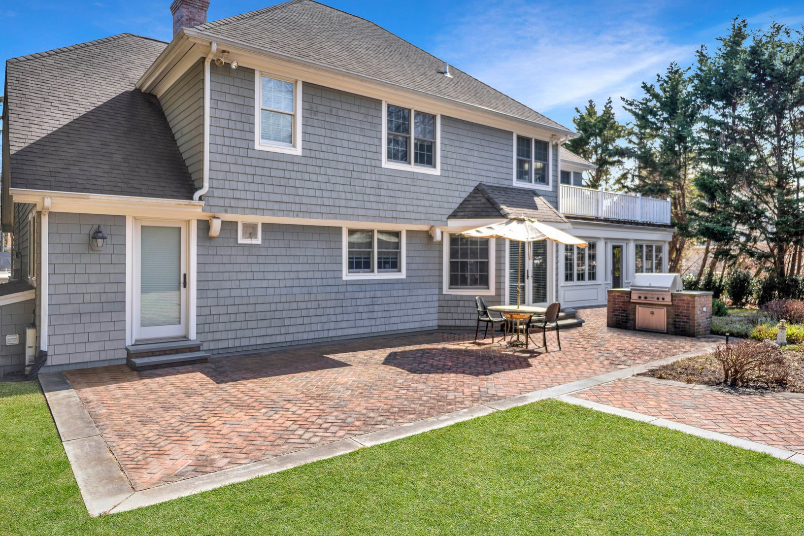  Spacious backyard brick patio with gas grill