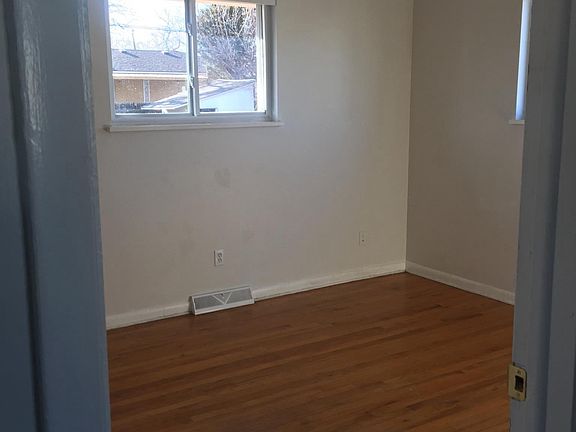 Upstairs bedroom with real wood floors and blackout blinds