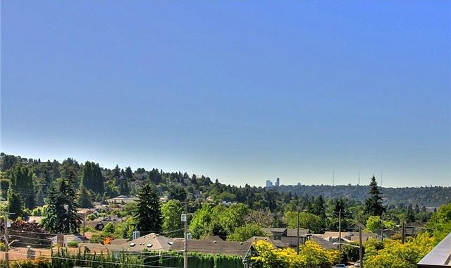 Wide open view from the roof deck. Seattle skyline in the d
