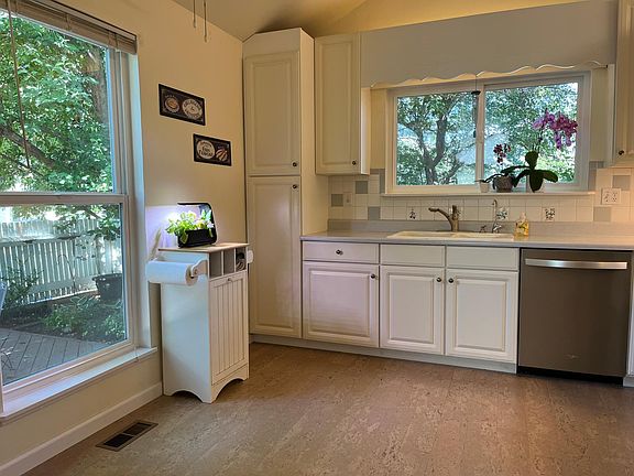 Kitchen with view of courtyard. Mountain view above sink when trees are bare