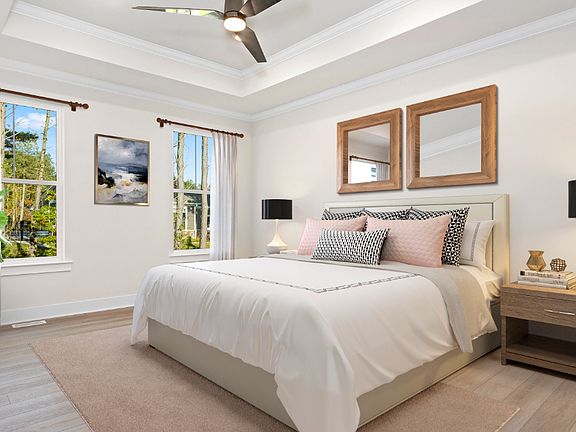 Owner s suite with tray ceiling and 2 large windows on one wall in DRB Homes Latitude home.