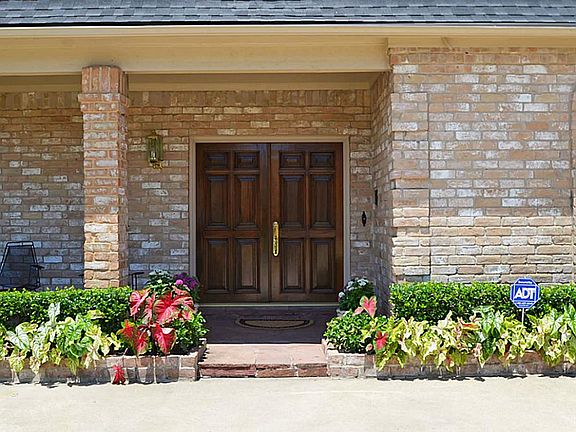 Inviting Flagstone Entry with Covered Front Porch and Solid Wood Double Doors!