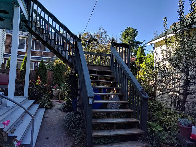 Stairs leading to 2nd story balcony and entrance to 2nd story rental space.