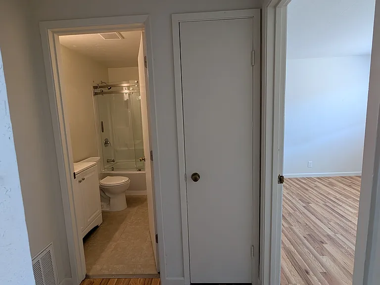 Hallway looking at bathroom, closet (closed), and room A