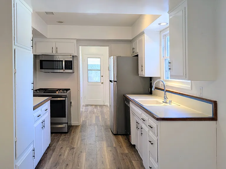Kitchen with refrigerator, stove & oven combo, and microwave