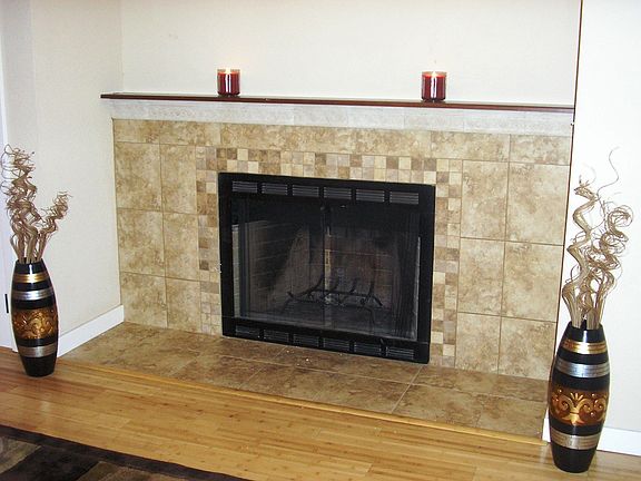 Elegant tiled fireplace provides a contemporary feel