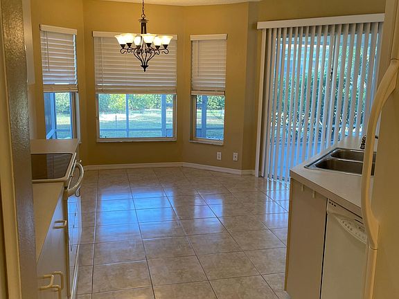 Eat in Kitchen, with pantry, refrigerator with ice maker, microwave, electric stove with oven and deposal. Ceramic tile floor kitchen, Hall and 2 nd bath.
