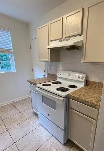 Kitchen with new paint on cabinets and stove