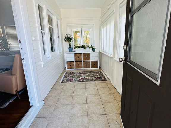 Tiled, enclosed porch/sun room.