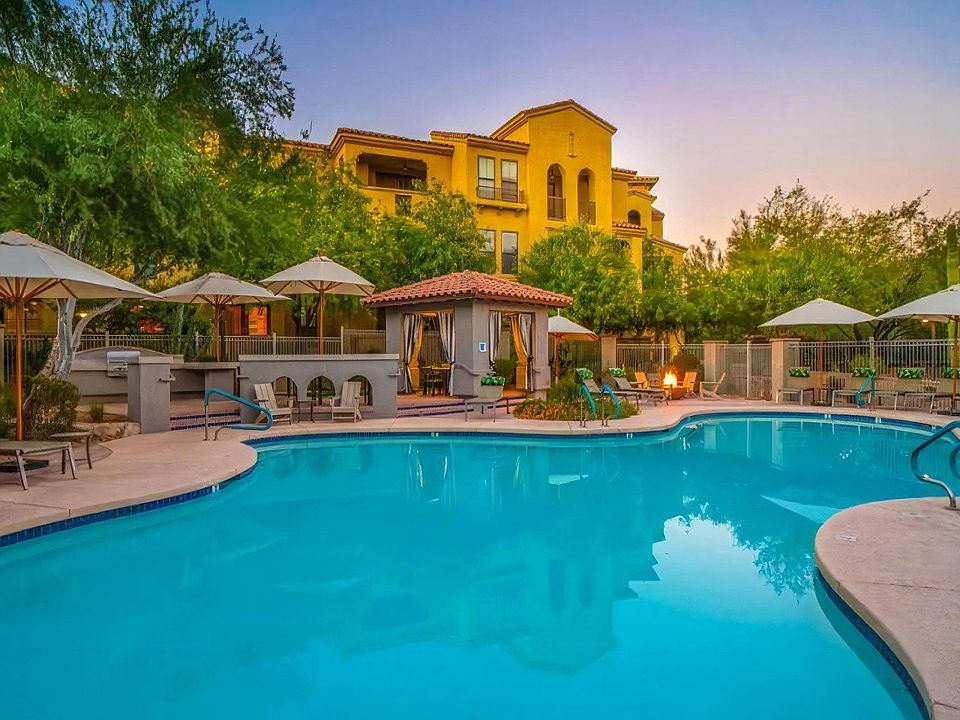 Resort-Style Pool Surrounded by Draped Cabanas and Shade Umbrellas
