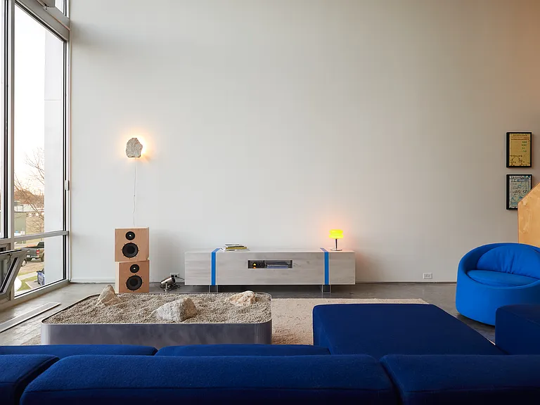 Living room with couch, chair and floor to ceiling windows