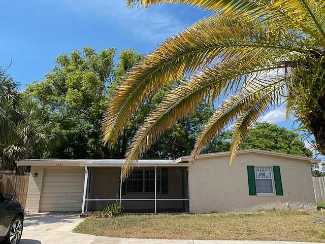 Front exterior with screened porch with tiled floor and circular drive