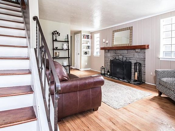 Beautiful hardwood floors and fireplace in Living Room. Glass block windows flank the fireplace.