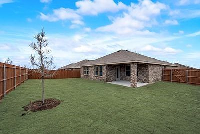 Large fenced in back yard with covered patio