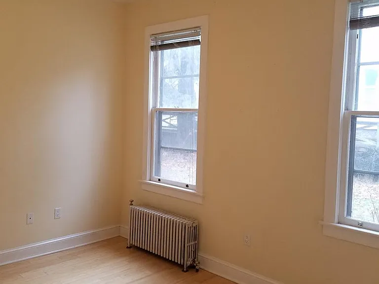 Living room windows bamboo hardwood throughout home.