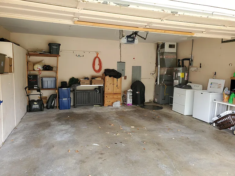 2 car garage with washer/dryer and storage cabinets