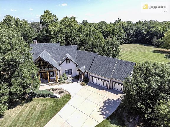 1.23 acres tucked away in the heart of Overland Park! Stunning elevation of custom home.