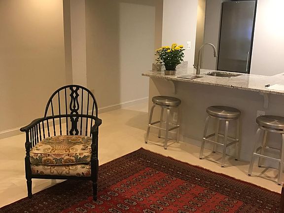 living area. Bar stools furnished, but not rug or chair