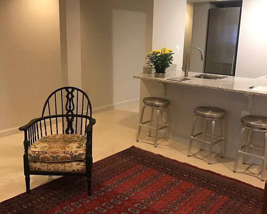 living area. Bar stools furnished, but not rug or chair