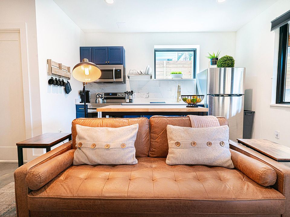 Enjoy your home away from home modern luxe studio with a full galley kitchen, leather sofa to relax and watch tv shows and movies.