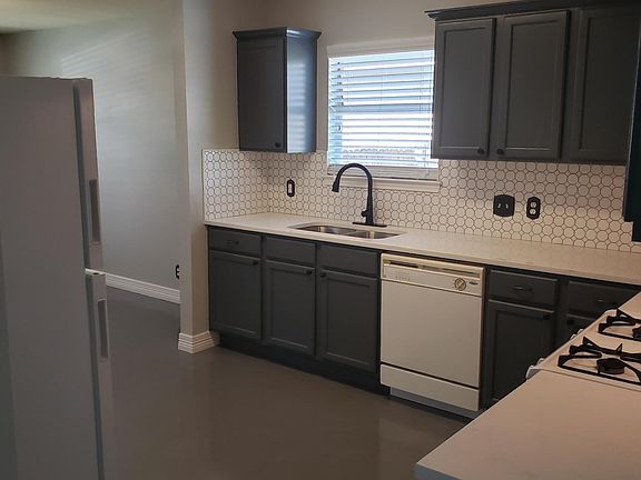 Polished concrete floors, quartz countertops, backsplash in kitchen Refrigerator and dishwasher included.