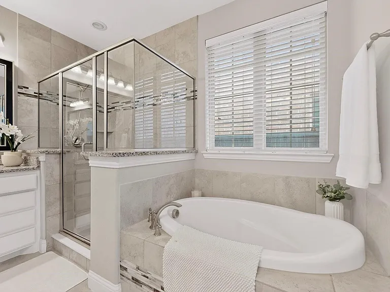 A spacious bathroom with a separate shower and tub, showcasing modern fixtures and a clean design.