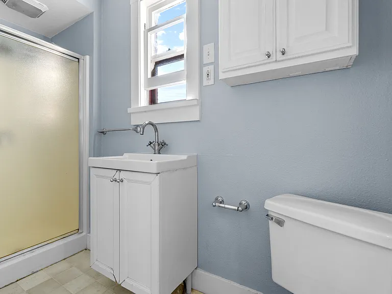 Bedroom 3 en-suite bath. Bathroom has been remodeled with tile flooring and pedestal sink. This room has already been rented and is no longer available.