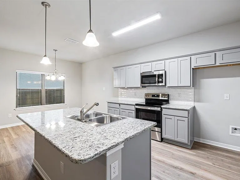 Granite counters, stainless steel appliances (Refrigerator not in photograph but included)
