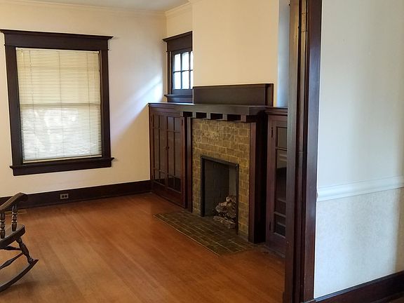 This picture was taken from the formal dining room, looking into the living room, with fireplace. The large window looks out on the front porch