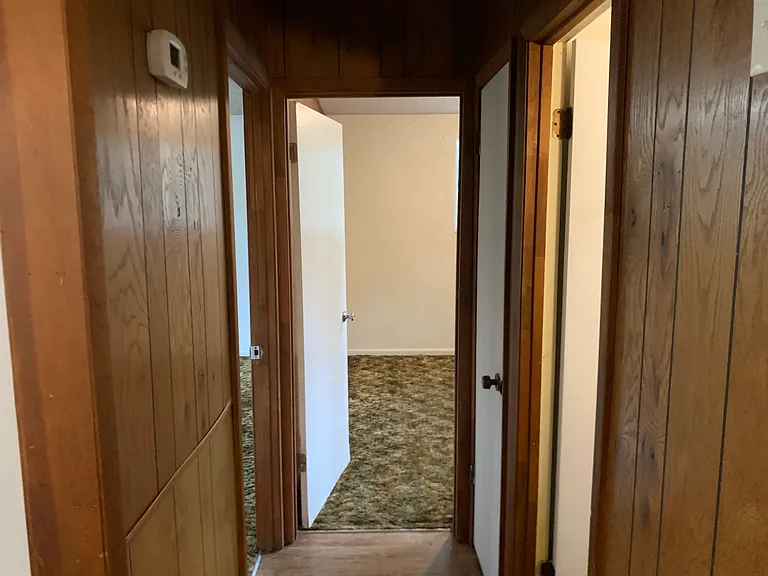 Hallway (Left Door: Bedroom 1; First Right Door: Bathroom; Back Door: Bedroom 2)