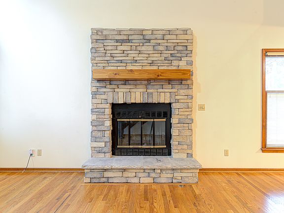 Stone surround wood burning fireplace