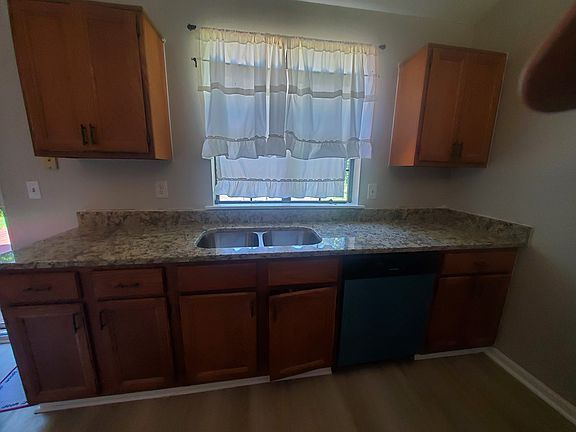 Gorgeous galley kitchen with new granite countertops, dishwasher, microwave and gas range.
