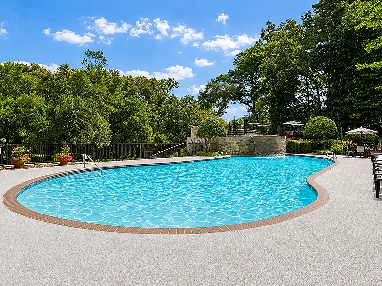 Relax by the pool in a peaceful outdoor setting.