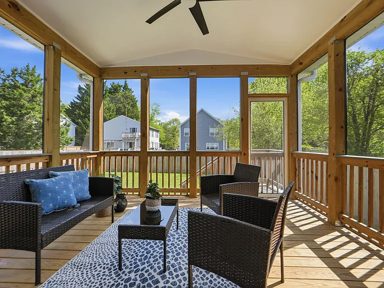 Beautiful backyard with large screened in porch, planter boxes, a grill pad, and a fire pit, ready to host your next family gathering!