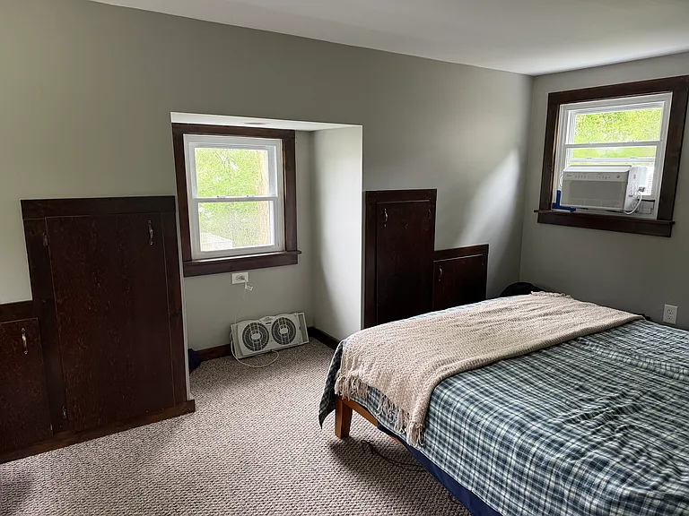 Upstairs bedroom with rustic built in storage cabinets.