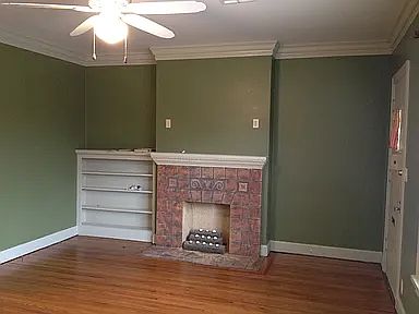 Living room with built-in shelves and 9 foot ceilings and crown molding.