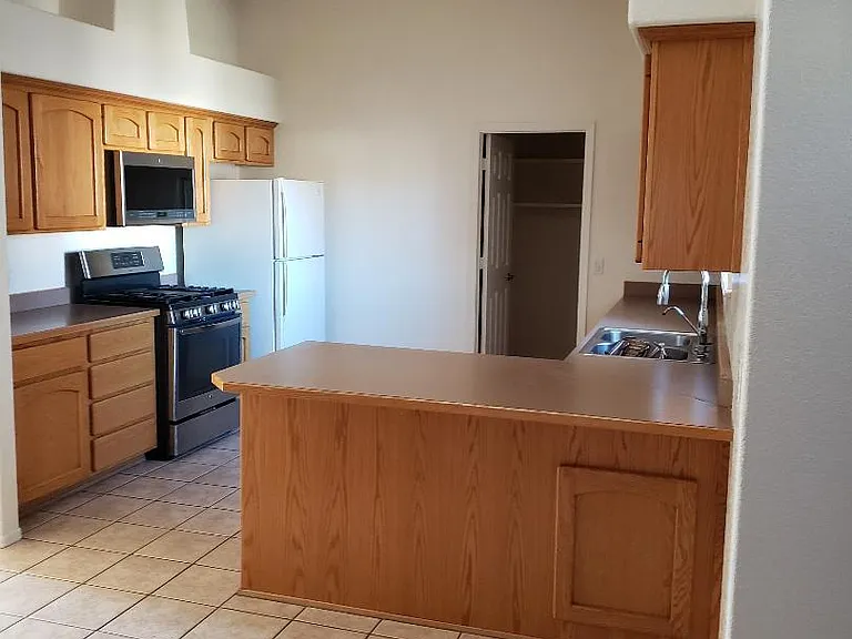 Kitchen with Gas Stove. Breakfast bar with under the counter exterior storage.