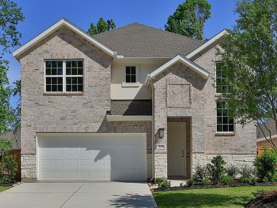 Sophisticated brick facade and gabled roof define luxury in The Woodlands Hills, Texas.