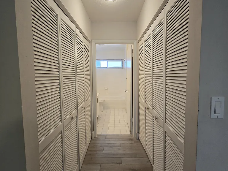 Hallway and closet to primary bathroom