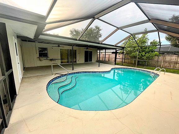 large pool area with fence yard and lots of shaded space for entertaining