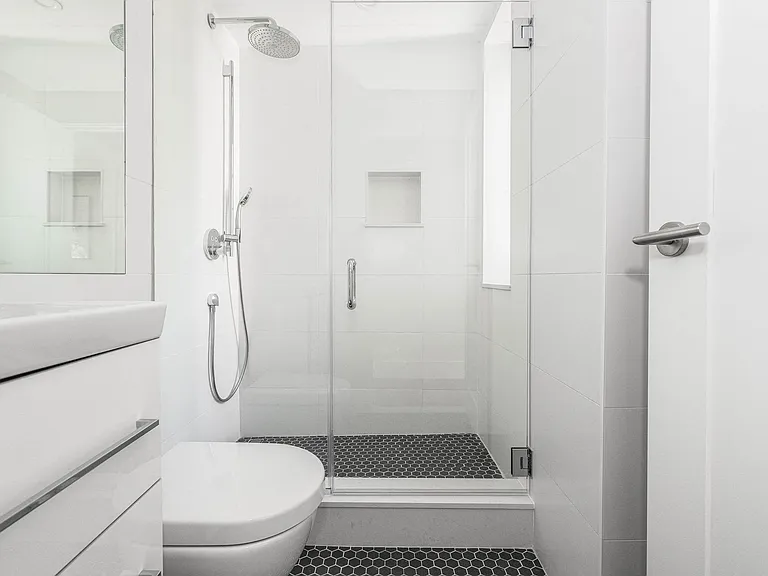 stylish bathroom with chrome fixtures and a rain shower