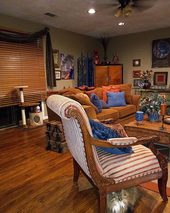 Den with view of corner TV/entertainment center.