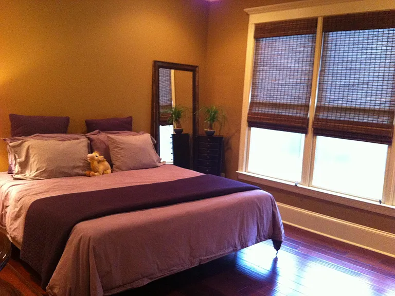 Master bedroom with windows looking on to private, fenced back yard.