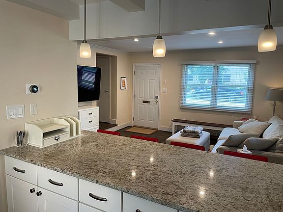 View over kitchen island and smart home Nest smart thermostat.