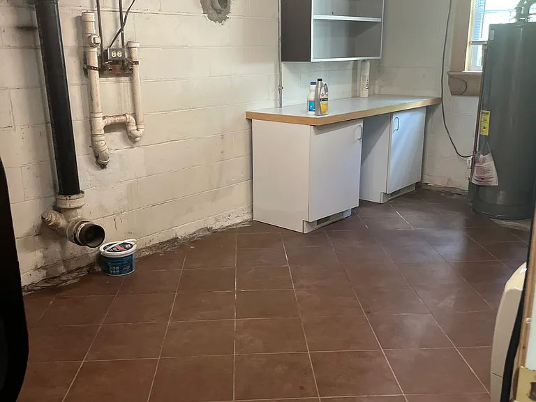 Large laundry room with gas dryer hook up and storage space.